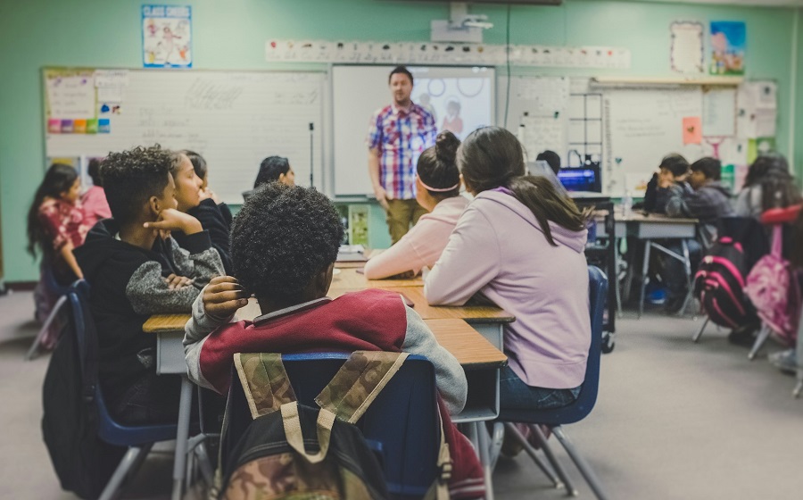 student sitting on classroom chairs with teacher