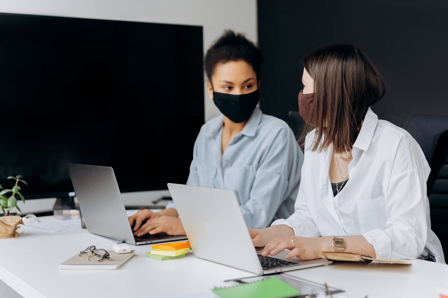 women working sitting in front of laptop